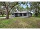 A cozy home with a well-maintained lawn, showcasing its charming windows and inviting entryway at 4513 Hidden River Rd, Sarasota, FL 34240