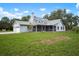 Charming single Gathering home showcasing a screened in porch and a two car garage on a sunny day at 4513 Hidden River Rd, Sarasota, FL 34240