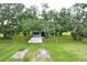 Quaint home nestled among mature trees offering privacy and seclusion, set back from the road at 4513 Hidden River Rd, Sarasota, FL 34240