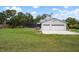 A two car garage providing plenty of space for vehicles and storage, complemented by a serene backyard setting at 4513 Hidden River Rd, Sarasota, FL 34240
