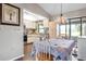 Cozy kitchen and dining area with tiled ceiling, vintage light fixture, and ample counter space at 4513 Hidden River Rd, Sarasota, FL 34240