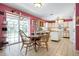 Eat-in kitchen boasting white cabinets, appliances, island, and large windows to the outdoor living space at 4513 Hidden River Rd, Sarasota, FL 34240