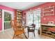 Kitchen eating area with table, tile floors, shelves, and a view through the large glass doors at 4513 Hidden River Rd, Sarasota, FL 34240