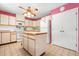 Bright kitchen featuring an island, neutral cabinetry, tile flooring, and modern appliances at 4513 Hidden River Rd, Sarasota, FL 34240