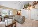 Bright living room with vaulted ceilings, comfortable seating, and tile flooring creates a welcoming gathering space at 4513 Hidden River Rd, Sarasota, FL 34240