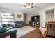 Inviting living room with ample seating, wood flooring, and a decorative heart wall hanging at 4513 Hidden River Rd, Sarasota, FL 34240