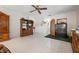 Bright living room featuring tile floors, ceiling fan, and wood furnishings, offering comfortable living space at 4513 Hidden River Rd, Sarasota, FL 34240