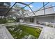 Backyard pool with a screened enclosure and paved patio at 4513 Hidden River Rd, Sarasota, FL 34240