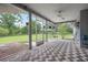 Inviting screened porch featuring a brick pattern floor and outdoor view at 4513 Hidden River Rd, Sarasota, FL 34240
