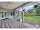 Screened patio boasts a brick floor, ceiling fan, and a peaceful outdoor view at 4513 Hidden River Rd, Sarasota, FL 34240