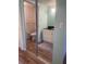 Bright bathroom featuring toilet, tiled shower, attractive vanity, and wood-look flooring at 4520 47Th W Ave # 103, Bradenton, FL 34210