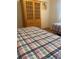 Bedroom with two twin beds and wooden armoire at 4520 47Th W Ave # 103, Bradenton, FL 34210