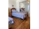 Bright bedroom with two twin beds, wood floors and mirror sliding closet doors at 4520 47Th W Ave # 103, Bradenton, FL 34210