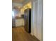 Well-lit kitchen featuring stainless steel refrigerator and wood flooring throughout at 4520 47Th W Ave # 103, Bradenton, FL 34210