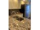 The kitchen features a stainless steel sink with updated fixtures and granite countertops at 4520 47Th W Ave # 103, Bradenton, FL 34210