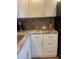 Bright kitchen features white cabinets, granite countertops, and stainless steel appliances at 4520 47Th W Ave # 103, Bradenton, FL 34210