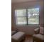 Cozy living room featuring large windows with a peaceful water view, and comfortable seating area at 4520 47Th W Ave # 103, Bradenton, FL 34210