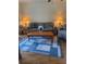 Living room with wood laminate flooring, sofa, and modern area rug at 4520 47Th W Ave # 103, Bradenton, FL 34210