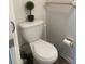 Close-up of a toilet with a small potted plant on top of the tank and a towel rack behind the toilet at 4520 47Th W Ave # 103, Bradenton, FL 34210