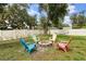 Cozy backyard with fire pit surrounded by colorful chairs, perfect for outdoor gatherings at 4565 Eldron Ave, North Port, FL 34286