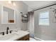 Bathroom featuring updated fixtures, marble countertops and an over-the-tub shower at 4565 Eldron Ave, North Port, FL 34286
