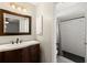Updated bathroom with a wooden vanity and tiled shower at 4565 Eldron Ave, North Port, FL 34286