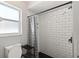 Updated bathroom with tiled shower featuring black hardware and patterned shower curtain at 4565 Eldron Ave, North Port, FL 34286