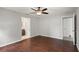Large bedroom with neutral walls, hardwood floors, and doorways to closet and bathroom at 4565 Eldron Ave, North Port, FL 34286