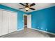 Blue bedroom featuring a ceiling fan, light wood floors, and a closet at 4565 Eldron Ave, North Port, FL 34286