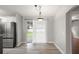 Bright dining area with new floors next to stainless steel appliances at 4565 Eldron Ave, North Port, FL 34286