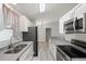 Well-lit kitchen featuring granite countertops, stainless steel appliances, and wood-look flooring at 4565 Eldron Ave, North Port, FL 34286