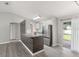 Modern kitchen featuring stainless steel appliances, granite countertops, and white cabinets at 4565 Eldron Ave, North Port, FL 34286