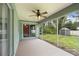 Enclosed lanai with ceiling fan, view of a grassy yard, and access to the home's interior at 4565 Eldron Ave, North Port, FL 34286