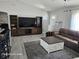 Spacious living room featuring modern furniture and a large entertainment center at 4565 Eldron Ave, North Port, FL 34286