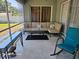 Cozy screened porch with comfortable seating and view of the backyard at 4565 Eldron Ave, North Port, FL 34286