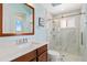 A modern bathroom with a glass walk-in shower and updated vanity at 4958 Gardiners Bay Cir, Sarasota, FL 34238