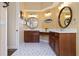 A spacious bathroom featuring dual vanities, framed mirrors, and contemporary tile flooring at 4958 Gardiners Bay Cir, Sarasota, FL 34238