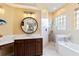 An updated bathroom with a soaking tub and a walk-in shower at 4958 Gardiners Bay Cir, Sarasota, FL 34238