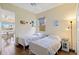 Bright bedroom with two beds, ceiling fan, and natural light at 4958 Gardiners Bay Cir, Sarasota, FL 34238