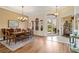 Elegant dining room with hardwood floors, chandelier, and natural light, perfect for formal dinners and gatherings at 4958 Gardiners Bay Cir, Sarasota, FL 34238