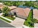 Beautiful one-story home featuring a red tile roof, manicured landscaping, and a spacious driveway with a three-car garage at 4958 Gardiners Bay Cir, Sarasota, FL 34238