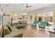 The open living room boasts hardwood floors and sliding glass doors leading to the lanai at 4958 Gardiners Bay Cir, Sarasota, FL 34238