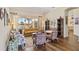 Cozy living room with hardwood floors, colorful decor, and large windows offering serene lake views and natural light at 4958 Gardiners Bay Cir, Sarasota, FL 34238