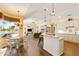 Open living space with a kitchen island, and seamlessly connecting the kitchen, dining area, and living room at 4958 Gardiners Bay Cir, Sarasota, FL 34238