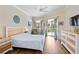 The main bedroom offers hardwood floors, abundant natural light, and private access to the lanai at 4958 Gardiners Bay Cir, Sarasota, FL 34238