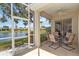 Covered patio with comfortable seating area overlooking a peaceful lake at 4958 Gardiners Bay Cir, Sarasota, FL 34238