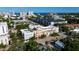 Real estate aerial showcasing a row of townhouses, trees, and in the distance a clear view of the ocean at 525 N Orange Ave # 302, Sarasota, FL 34236
