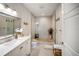 Bright bathroom features a modern vanity, large mirror, and walk-in shower with stone flooring at 525 N Orange Ave # 302, Sarasota, FL 34236