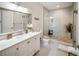 Bright bathroom features a modern vanity, large mirror, and walk-in shower with stone flooring at 525 N Orange Ave # 302, Sarasota, FL 34236