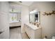 Bathroom view with vanity, mirror, and a glimpse into the adjacent bedroom at 525 N Orange Ave # 302, Sarasota, FL 34236